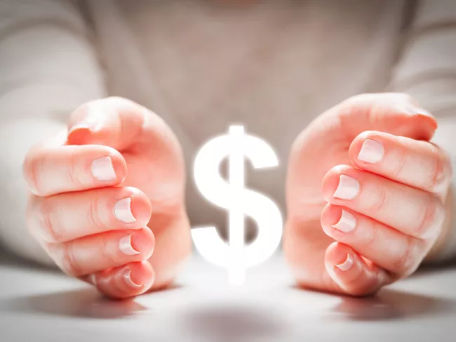Dollar sign between hands