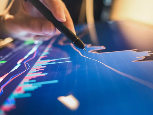 Hand, stylus pointing at graph on screen