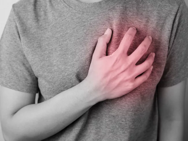 Woman in pain holding hand over heart