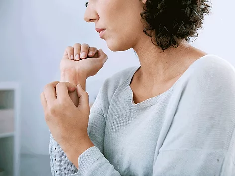 Woman itching wrist