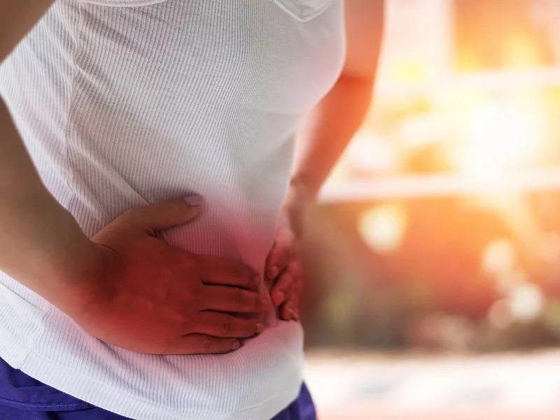 Person holding stomach in pain Person holding stomach in pain