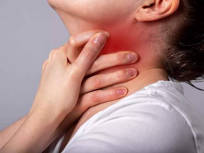 Woman in distress holding neck