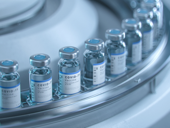 COVID-19 vaccine vials on conveyor belt