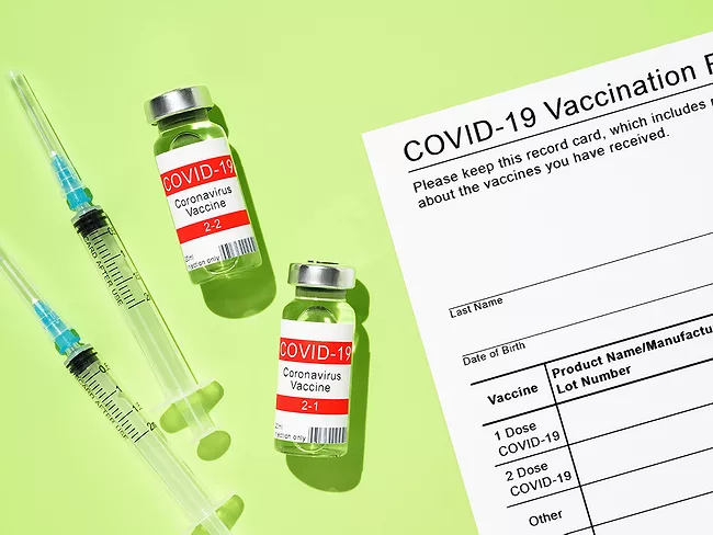 COVID-19 vial, syringe and vaccine card