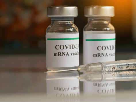 COVID-19 mRNA vaccine vials, syringe