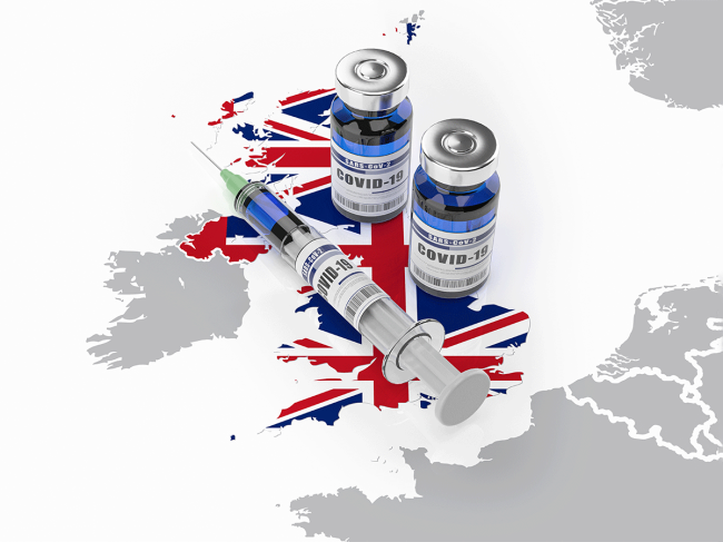 Syringe, bottles of COVID-19 vaccine on U.K. map