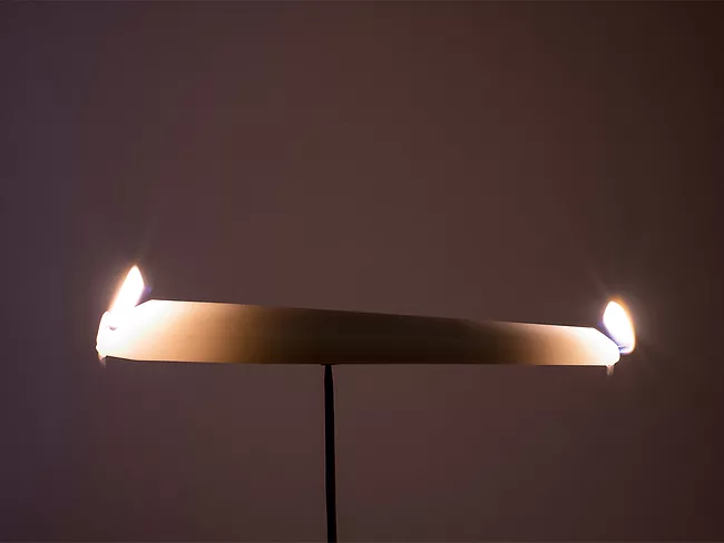 Photo of candle burning at both ends