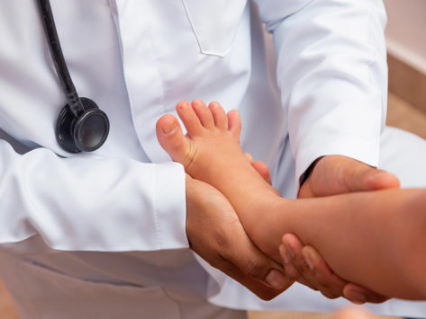 Doctor examining child's leg