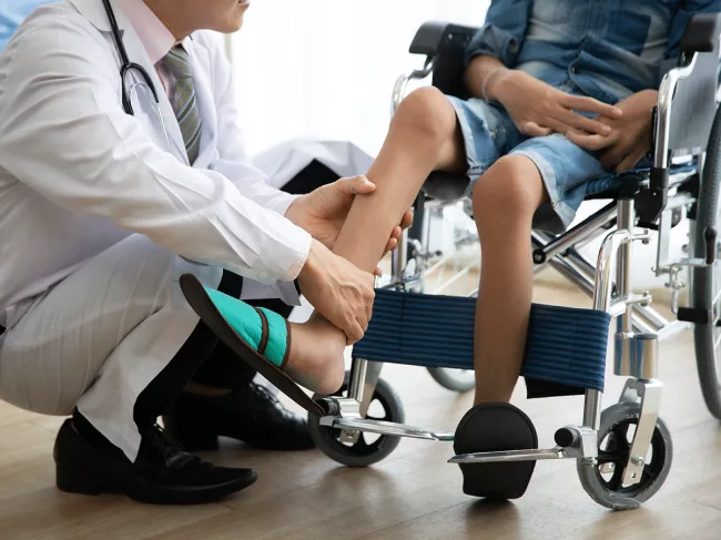 Doctor examining child in wheelchair
