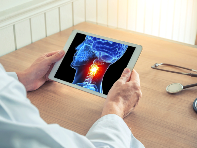 Doctor holding digital tablet with image of skull