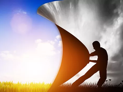 Man pulling back clouds for sunshine