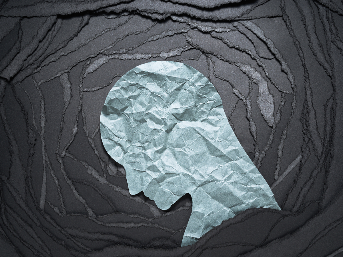 Silhouette made of crumpled paper illustrating depression