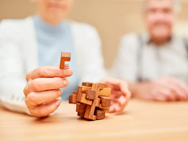 Seniors with wooden puzzle