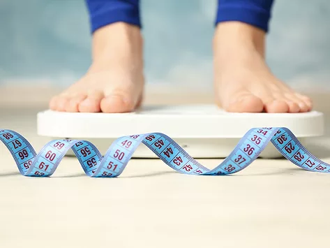 Feet on scale and measuring tape