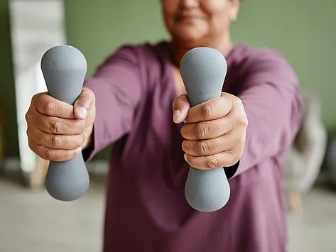 Woman exercising with hand weights