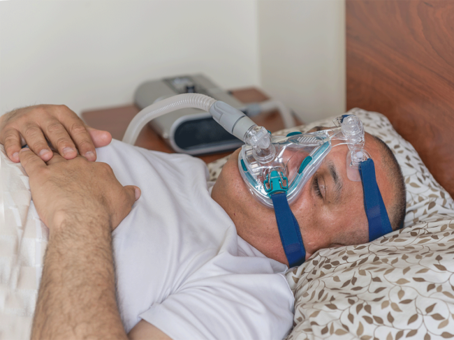 Man sleeping with CPAP machine