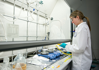 A researcher with Interface Biologics works in the company's lab. The company develops polymers additives and drug delivery devices.