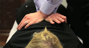 A patient receives a chiropractic thoracic adjustment