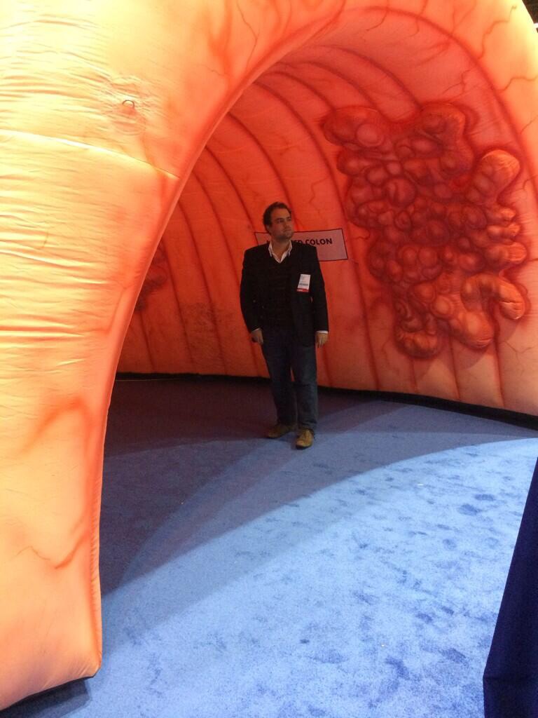 A DDW attendee stands in an inflatable colon tunnel on the exhibit floor in May.
